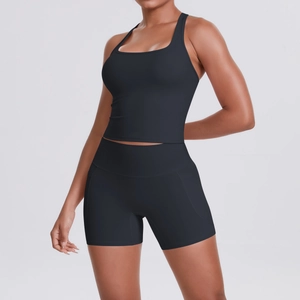 Detail of black sports set featuring a square neck tank top and high waist shorts with pockets