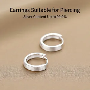 Minimalist 999 sterling silver hoop earrings with a matte brushed finish and smooth inner rim