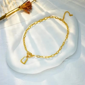 18K gold plated titanium steel chain necklace with white shell pendant on a white tray