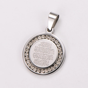 Macro shot of 18k gold-plated round pendant with inlaid diamonds and Arabic engraving