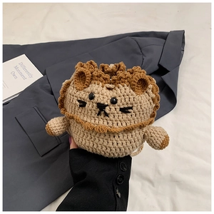 Detailed close-up of handmade crochet lion bag with beige and brown knit texture