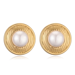 Macro shot of 18K gold plated heart earrings featuring a vintage textured pearl center