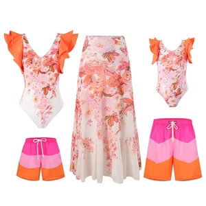 Matching family beachwear set with floral swimsuits and wave pattern swim trunks
