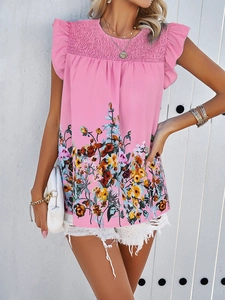 Close-up of pink floral sleeveless top with ruffled shoulders and pleated neckline detail