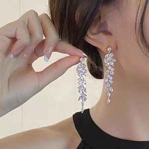 Close-up of elegant leaf-shaped fringe earrings with shimmering white marquise crystals