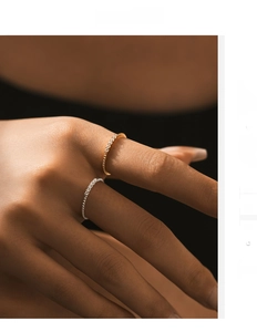 Close-up of minimalist gold and silver S925 rings with sparkling pavé moissanite stones