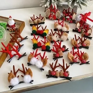 Detailed view of festive Christmas hair clips featuring reindeer antlers and plush pom-poms