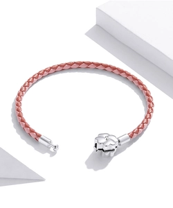 Detail of pink woven leather bracelet with silver four-leaf clover metal clasp