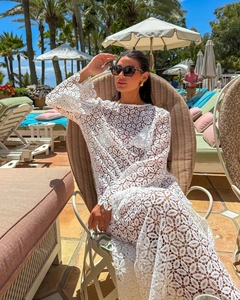 Detailed texture of white lace crochet dress with elegant summer beach vacation style