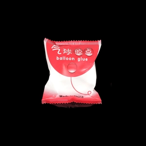 Red and white retail package of balloon glue dots for balloon and cake decoration