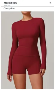 Detailed view of cherry red long sleeve yoga top and high-stretch sports shorts on model