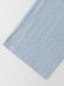 Detail of light blue vertical striped linen fabric and high-quality hem stitching