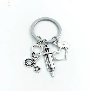 Detailed close-up of retro silver medical keychain with stethoscope and syringe charms