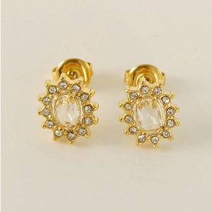 Close-up of golden sunflower stud earrings with large oval zircon and pavé diamonds