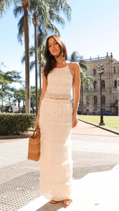 Close-up of white halter ruffle top and tiered maxi skirt in textured crinkle fabric