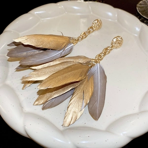 Vintage gold feather tassel earrings with bohemian textured round studs and metal chains