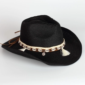 Detail of black woven straw cowboy hat with shell ornaments and tassel decoration