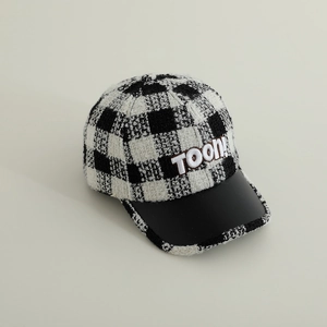 Detail of plaid baseball cap with TOON embroidery and black leather brim
