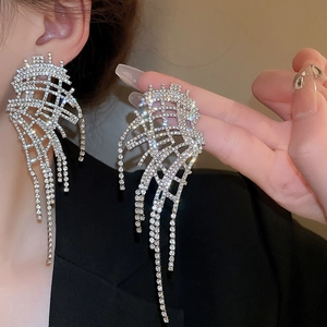 Detail of silver geometric fringe earrings with rhinestones and faux pearl accents