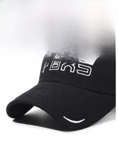 Macro detail of FBXS embroidered letter on a structured black canvas baseball cap