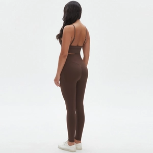 Detail of dark brown seamless yoga set featuring thin straps and high-waist leggings