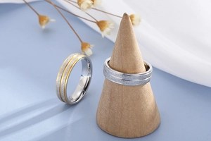 Detailed view of matte sandblasted finish on gold and silver stainless steel rings