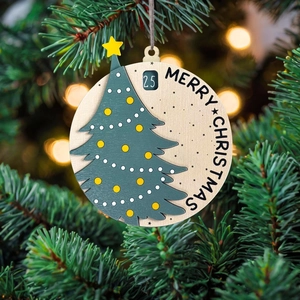 Wooden Santa Slider Countdown Christmas Calendar hanging on a pine tree with warm bokeh lights