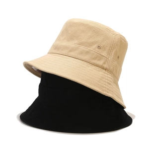 Detail of cotton bucket hats with ventilation eyelets and stitched brim in beige and black