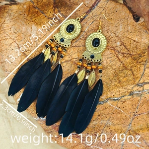 Close-up showing black natural feathers and intricate beadwork on bohemian earrings