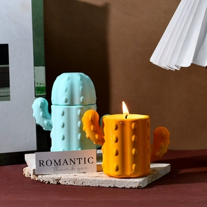 Cactus-shaped storage jar and yellow scented candle with realistic prickly texture