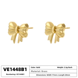 Detailed view of 18K gold-plated brass bow earrings showing 17x20mm size and 2.3g weight