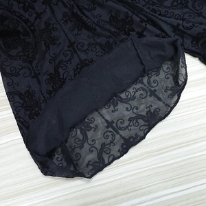 Detailed close-up of Gothic black lace fabric featuring cross and rose embroidery motifs