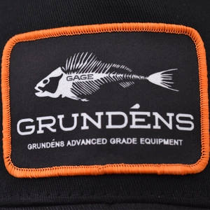 Trucker hat patch with fish bone embroidery and orange stitching on black canvas
