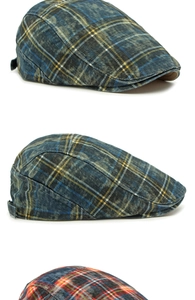 Detail view of retro plaid beret flat caps in washed cotton with contrast stitching