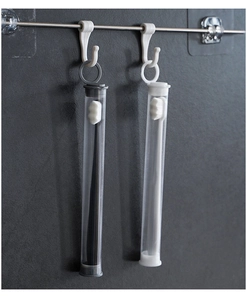 Detail of black and white nano toothbrushes in transparent storage cases on a wall rack