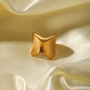 Minimalist gold-plated irregular concave ring with brushed metallic finish on satin