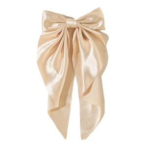 Elegant champagne satin bow hair clip with long streamers on white background
