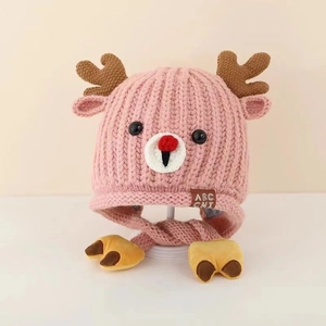 Detailed macro of pink knit baby hat with deer antlers and thick fleece lining texture