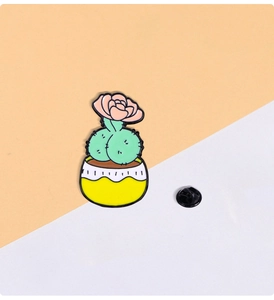 Detail of creative cartoon cactus enamel pin with pink flower and rubber back clasp