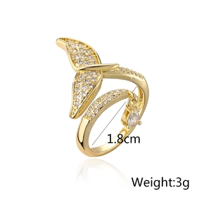 Detail of gold fishtail ring featuring white crystals and teardrop pendant with dimensions