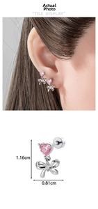 Detailed size view of silver bow stud earrings with a pink heart zircon stone