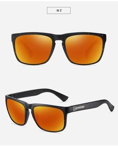 Detail of matte black sports sunglasses with yellow speckles and orange mirrored lenses