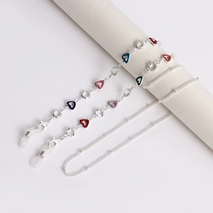Close-up of silver glasses chain with colorful heart charms and lobster clasps