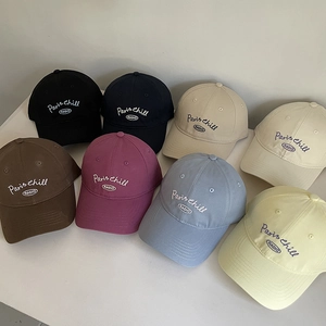 Detail view of cotton baseball caps with Paris embroidery in eight assorted colors
