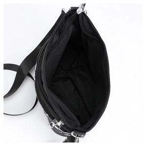 Interior view of black gothic skull crossbody bag showing main compartment and zip pocket