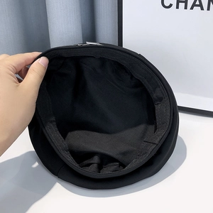 Detail view showing adjustable drawstring lining inside black cotton beret hat