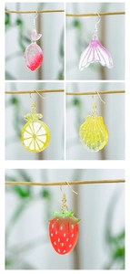 Collection of handmade resin earrings featuring starfish, shells, and fruit shaped designs
