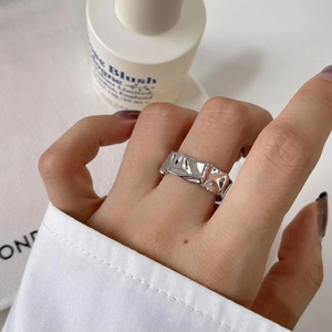 Macro detail of minimalist S925 sterling silver ring with irregular hammered texture