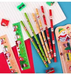 Flat lay of 5-piece Christmas stationery set with pencils, rulers and festive erasers