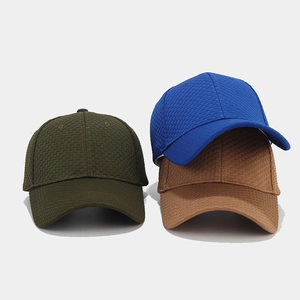 Detailed view of waffle textured baseball caps in olive, royal blue and caramel